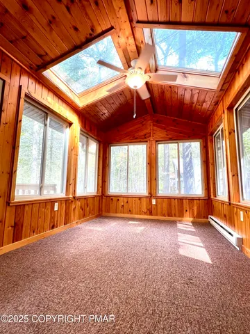 an empty room with furniture and windows