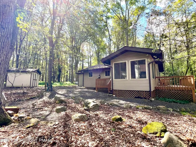 a white house that has a tree in front of it