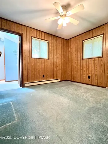 an empty room with closet and windows