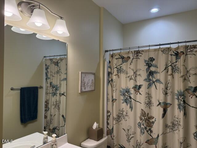 574 East Ridge Avenue Liberty, NC 27298 - Photo 16 of 28 a bathroom with a shower curtain and a mirror