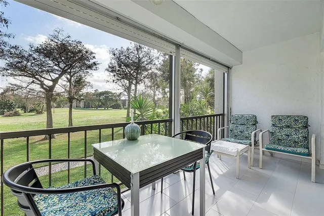 a view of a patio with a table chairs and a potted plant