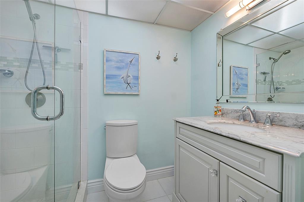 6080 Northwest 44th Street, Unit 214 Lauderhill, FL 33319 - Photo 14 of 17 a bathroom with a granite countertop toilet sink and mirror