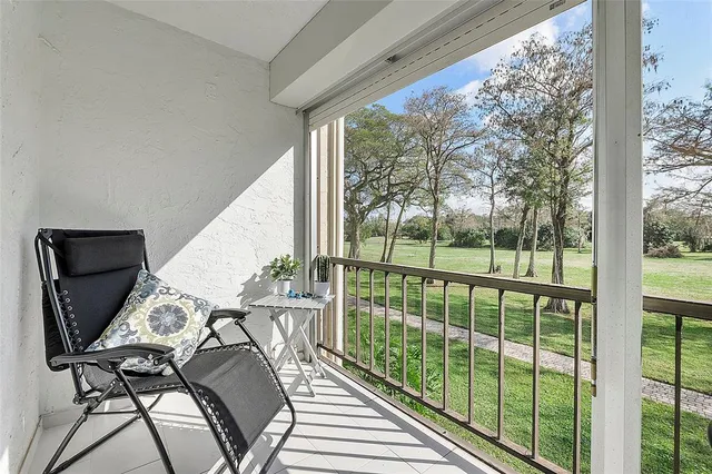a view of a chairs and table in patio with a yard