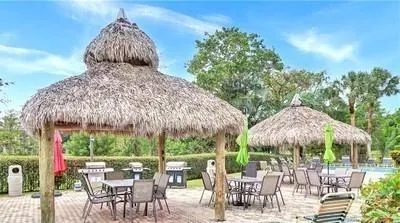a view of a swimming pool with outdoor seating