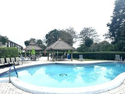 6080 Northwest 44th Street, Unit 214 Lauderhill, FL 33319 - Photo 17 of 17 a view of a swimming pool with outdoor seating