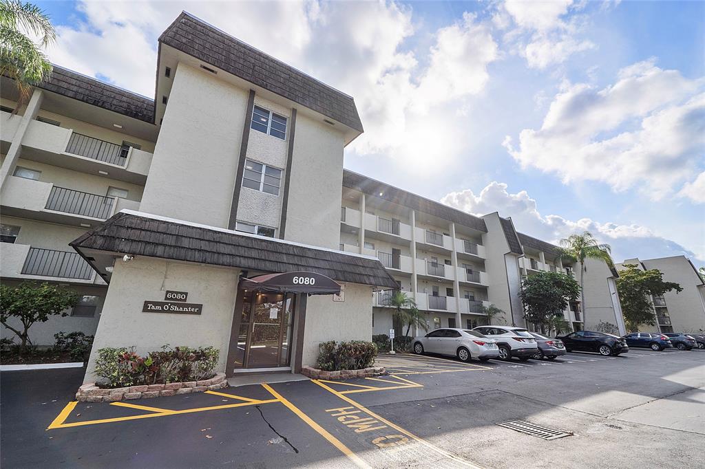 6080 Northwest 44th Street, Unit 214 Lauderhill, FL 33319 - Photo 2 of 17 a front view of a building with parking