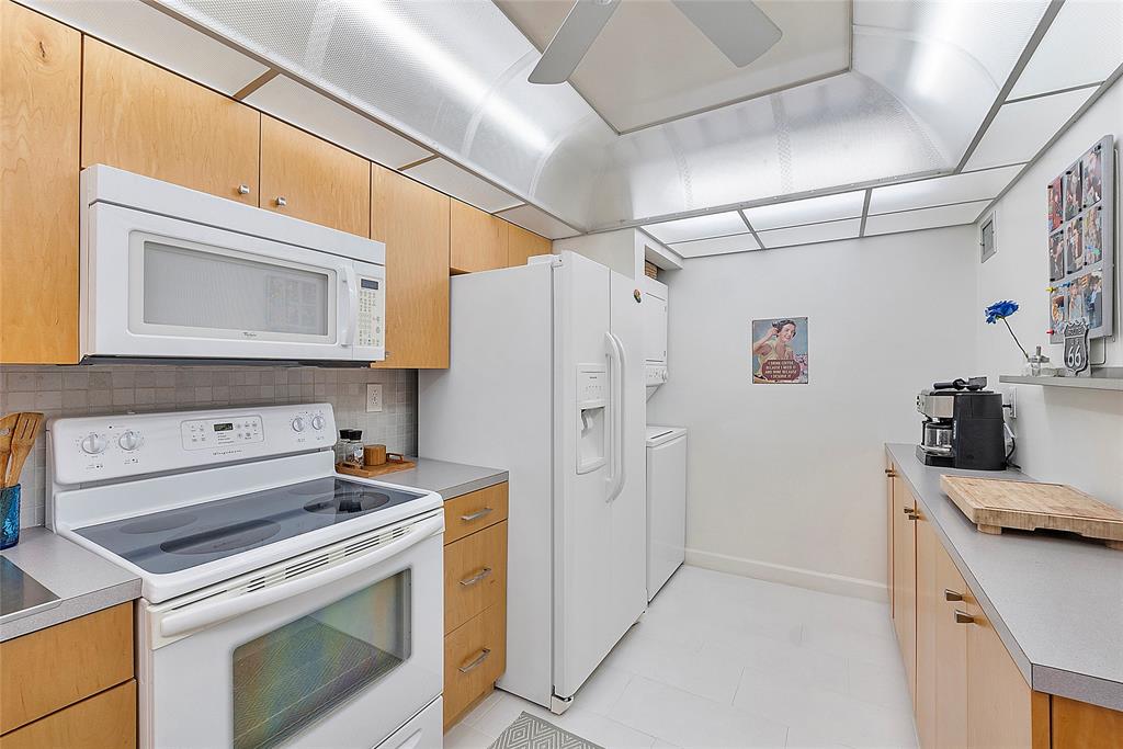 6080 Northwest 44th Street, Unit 214 Lauderhill, FL 33319 - Photo 5 of 17 a kitchen with stainless steel appliances a stove microwave and refrigerator