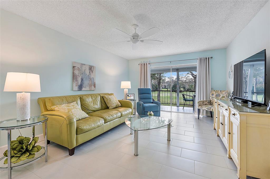 6080 Northwest 44th Street, Unit 214 Lauderhill, FL 33319 - Photo 7 of 17 a living room with furniture and a flat screen tv