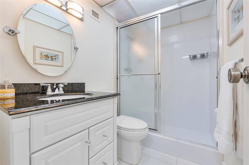 6080 Northwest 44th Street, Unit 214 Lauderhill, FL 33319 - Photo 9 of 17 a bathroom with a sink a toilet and a mirror