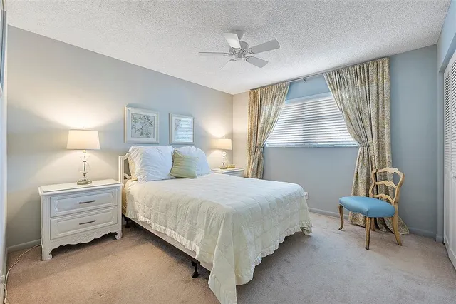 a spacious bedroom with a bed and a chandelier