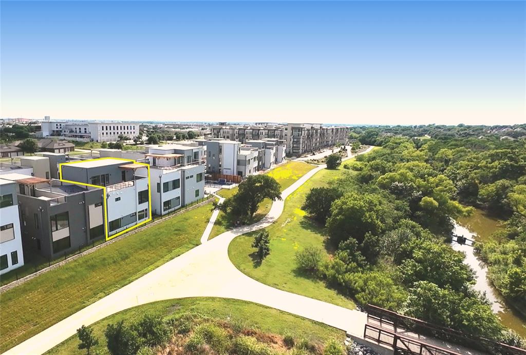 1111 Raiford Road, Unit 128 Carrollton, TX 75007 - Photo 2 of 18 Contemporary multistory residence featuring an integrated roof terrace and back patio. Highlighted unit is #128. Back faces trail, front faces the lane that 24 homes are located on. Boutique high-end community in a fabulous location.
