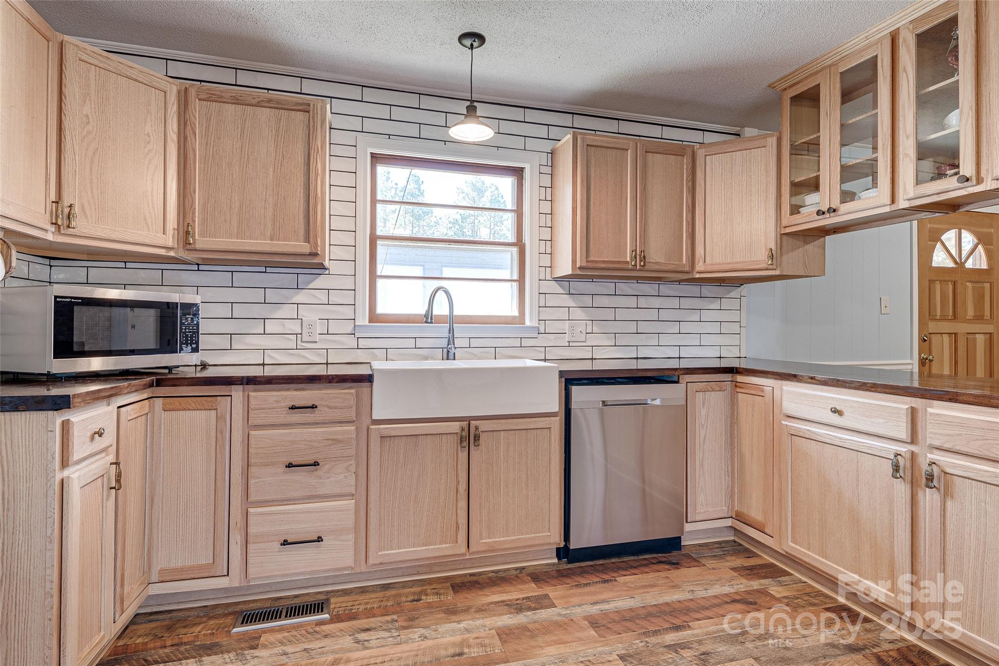 8684 Teals Mill Road Cheraw, SC 29520 - Photo 18 of 36 a kitchen with stainless steel appliances granite countertop a sink stove and cabinets