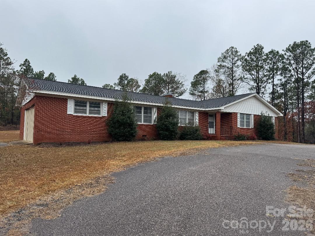 8684 Teals Mill Road Cheraw, SC 29520 - Photo 21 of 34 a front view of a house with a yard and garage