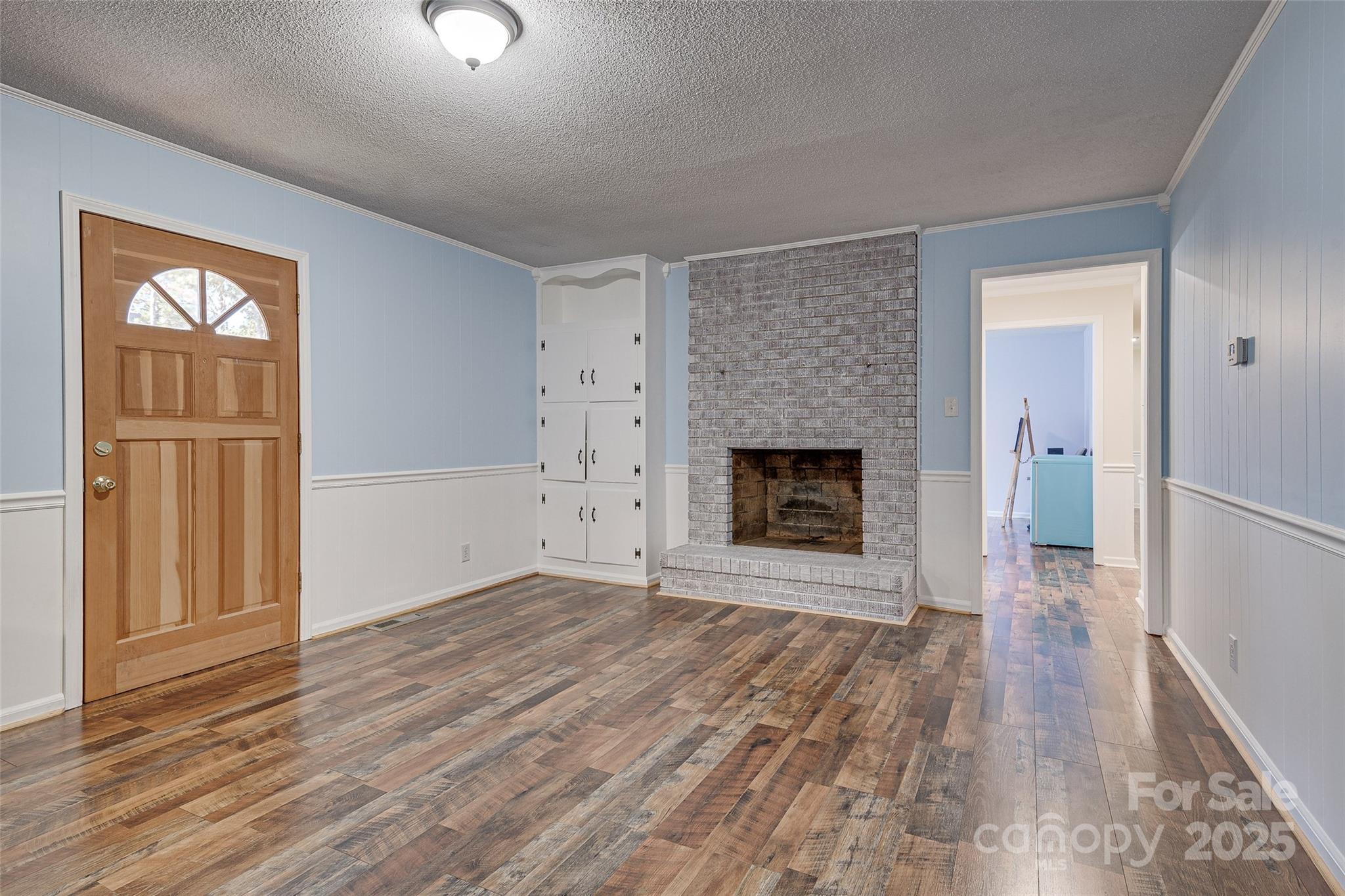 8684 Teals Mill Road Cheraw, SC 29520 - Photo 24 of 36 wooden floor fireplace and windows in an empty room