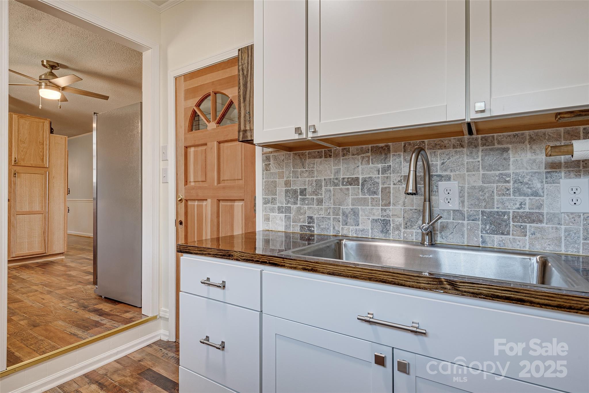 8684 Teals Mill Road Cheraw, SC 29520 - Photo 27 of 36 a kitchen with granite countertop a sink and a refrigerator