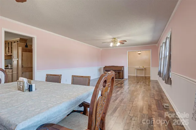 a dining room with furniture and wooden floor