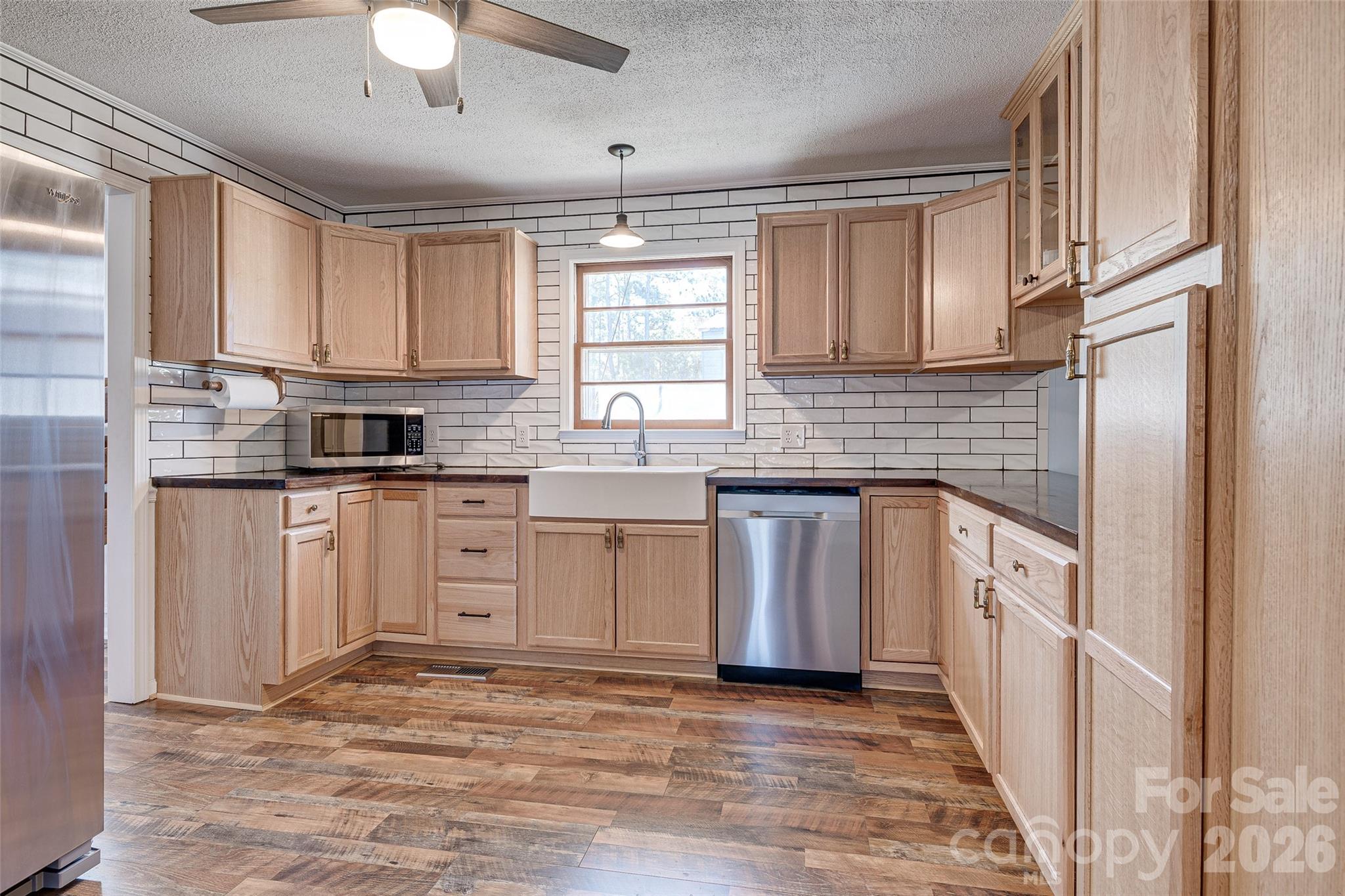 8684 Teals Mill Road Cheraw, SC 29520 - Photo 4 of 34 a kitchen with white cabinets stainless steel appliances a sink and a window