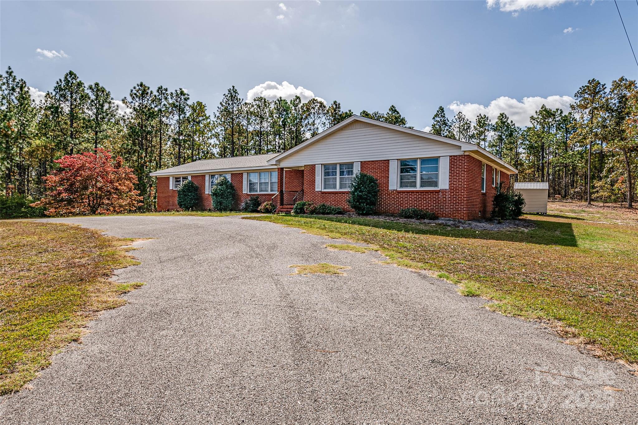 8684 Teals Mill Road Cheraw, SC 29520 - Photo 5 of 36 a front view of a house with a yard and trees