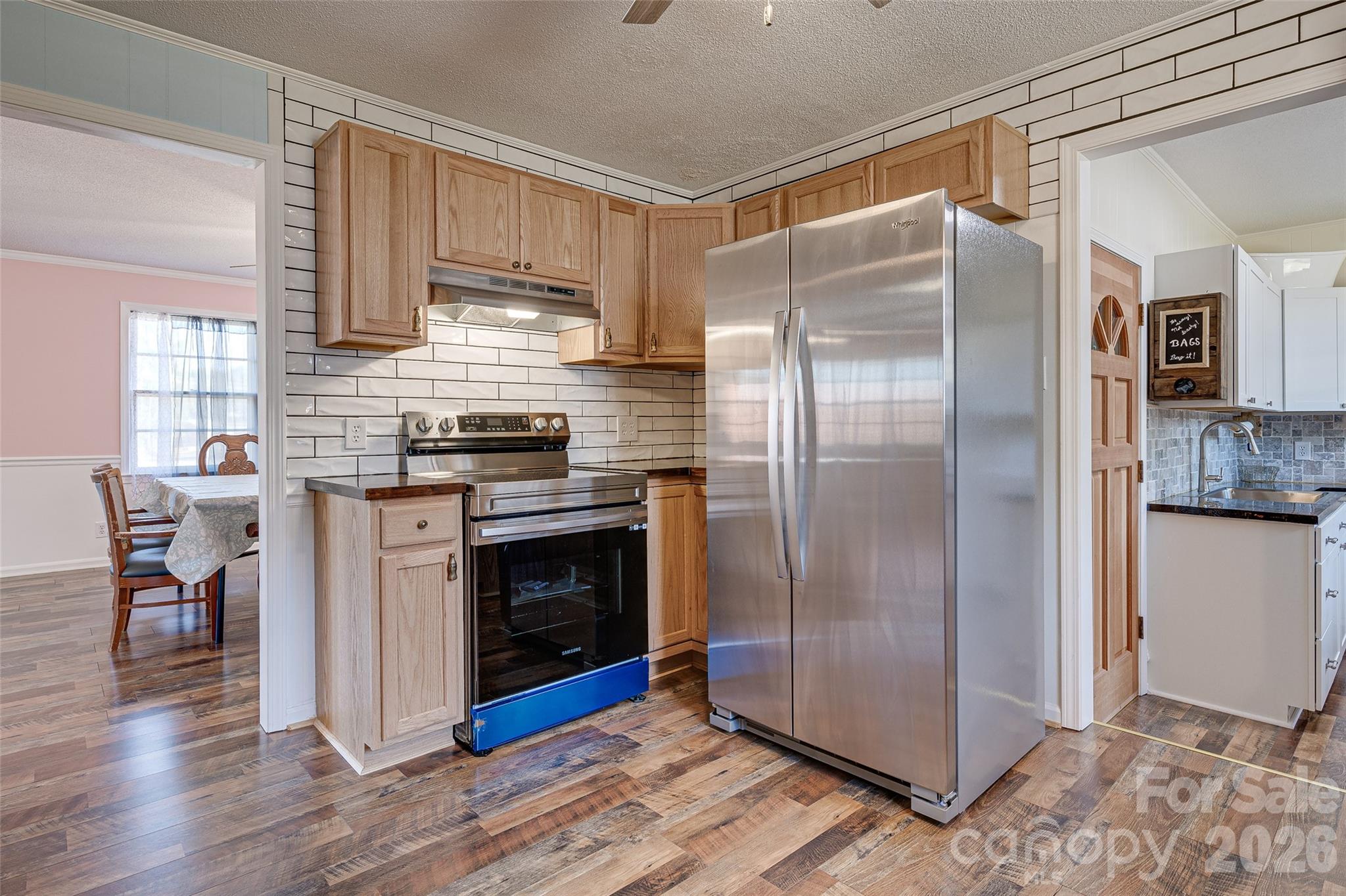 8684 Teals Mill Road Cheraw, SC 29520 - Photo 9 of 34 a kitchen with granite countertop a refrigerator and a stove