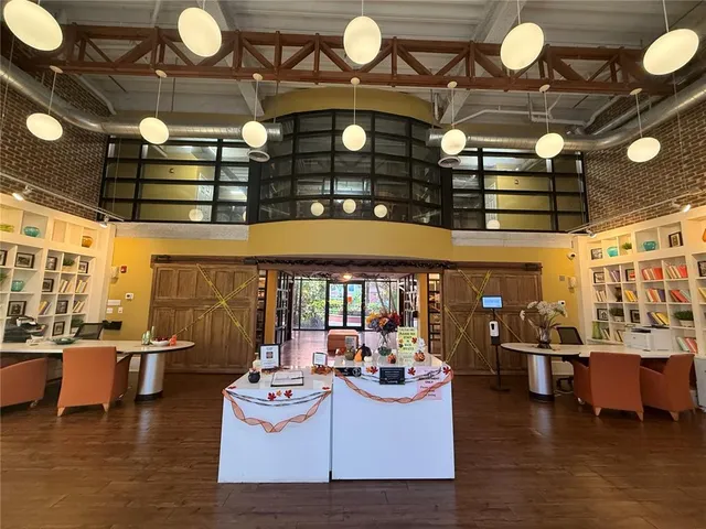 a living room with patio furniture and a chandelier