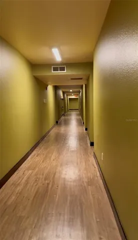 a view of a room with wooden floor