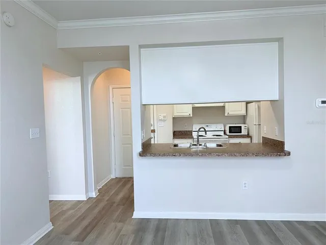 a view of kitchen with stainless steel appliances granite countertop and sink