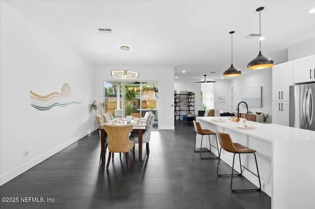 a kitchen that has a lot of cabinets in it and appliances