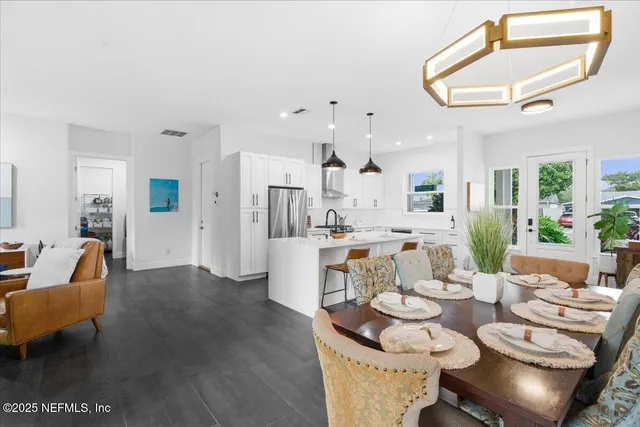 a kitchen with stainless steel appliances granite countertop white cabinets and a stove a oven with white countertops