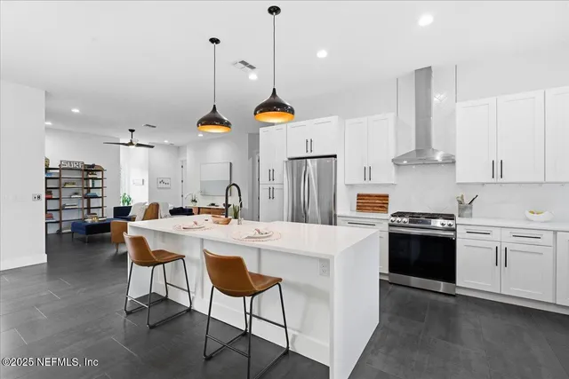 a living room with furniture and a book shelf