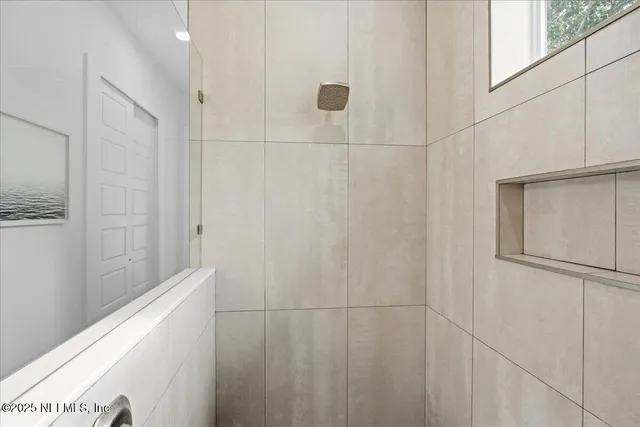 a kitchen with a stove a sink and a potted plant