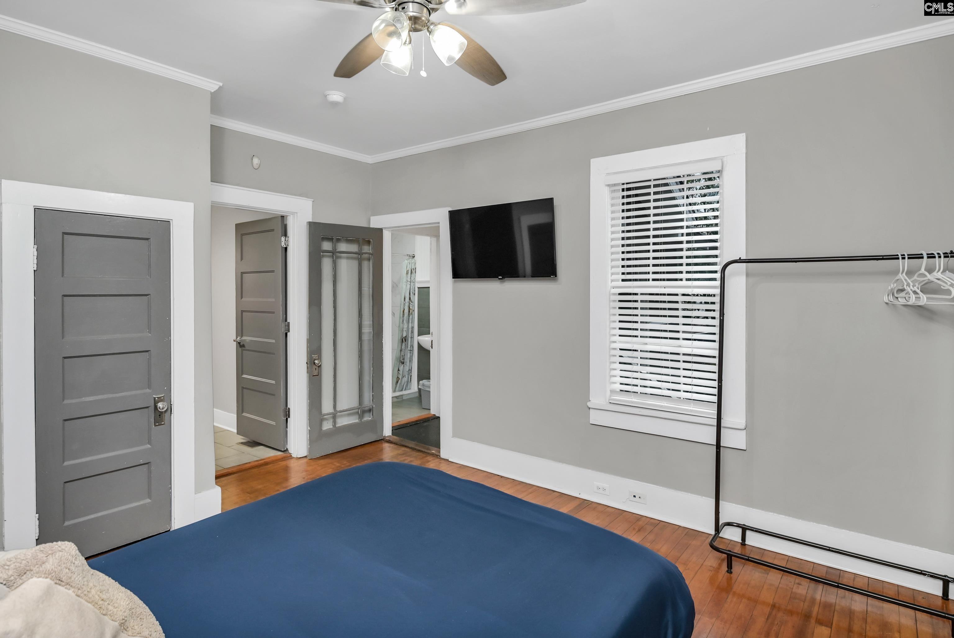2227 Bull Street Columbia, SC 29201 - Photo 18 of 38 a bedroom with a bed and a flat screen tv