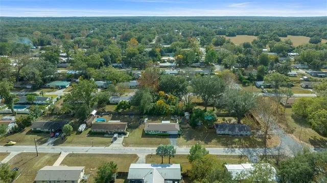 an aerial view of a house with yard swimming pool and outdoor seating