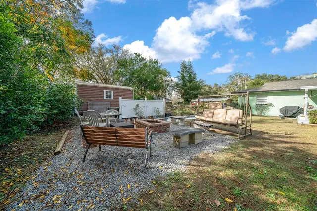 a backyard of a house with table and chairs