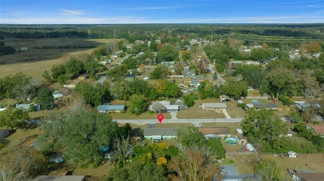 an aerial view of residential house with outdoor space and lake view