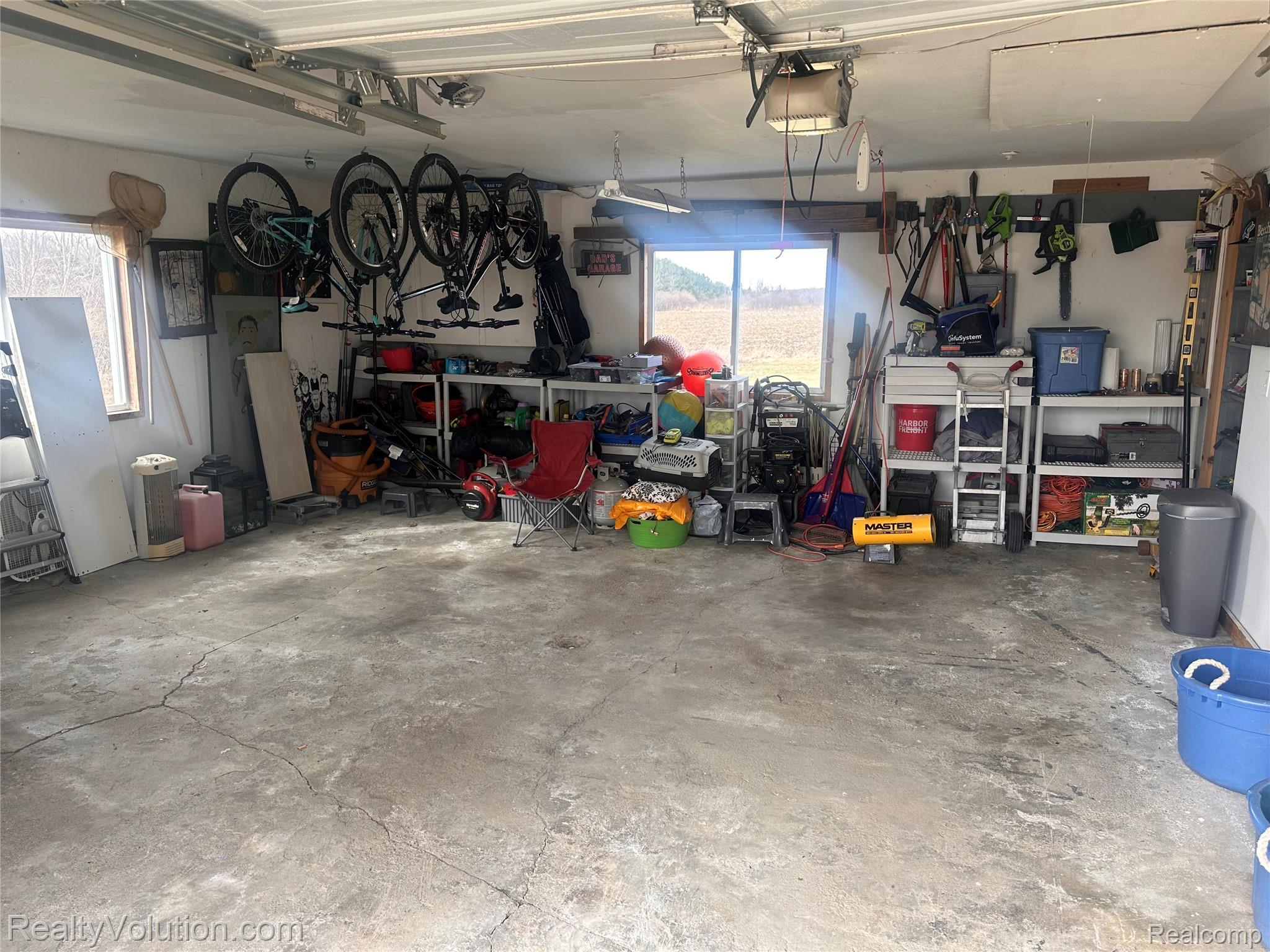 3034 West Oregon Road Lapeer, MI 48446 - Photo 28 of 29 Garage with a garage door opener and a workshop area
