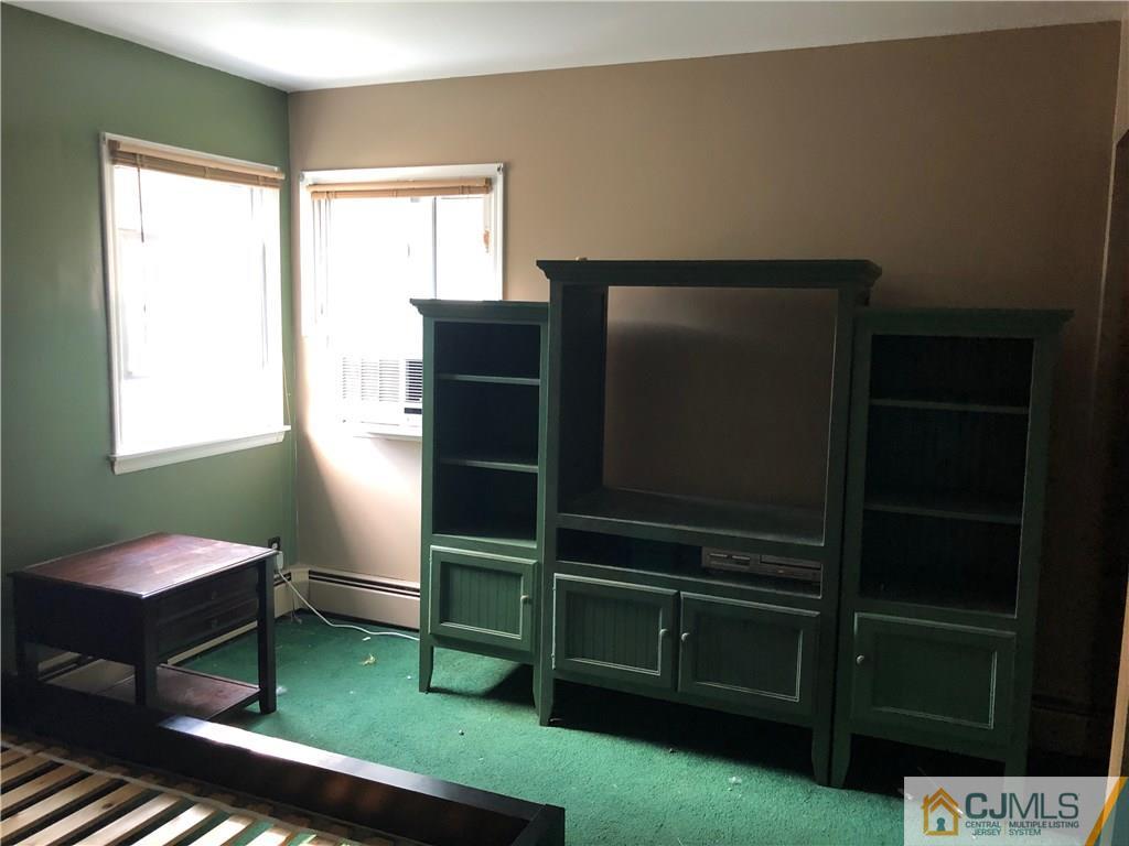 160 Winthrop Road Edison, NJ 08817 - Photo 14 of 18 a living room with furniture a lamp and a window