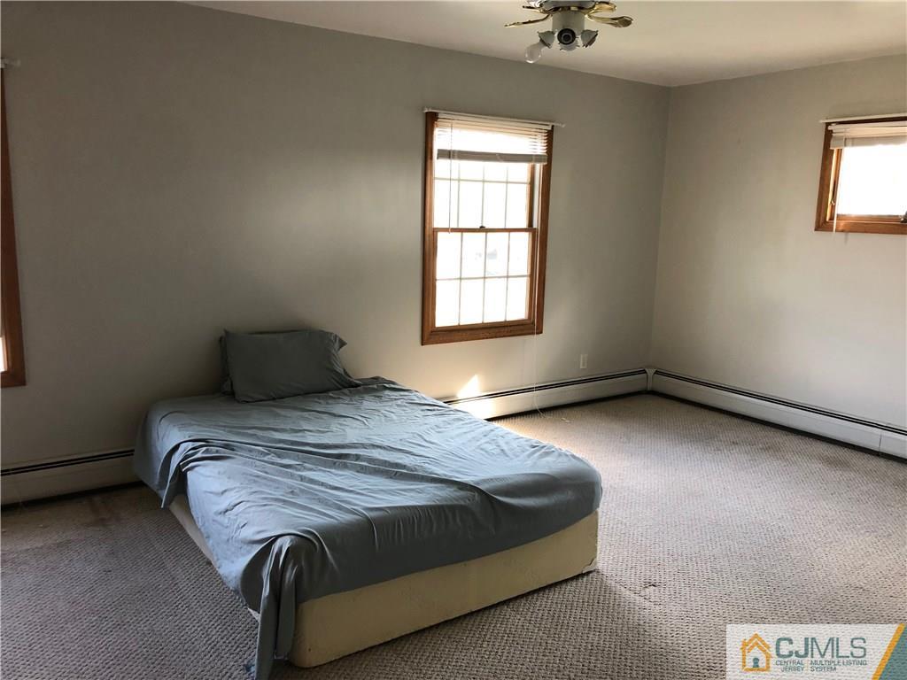 160 Winthrop Road Edison, NJ 08817 - Photo 17 of 18 a bedroom with a bed and a window