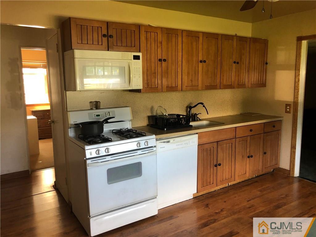 160 Winthrop Road Edison, NJ 08817 - Photo 10 of 18 a kitchen with stainless steel appliances granite countertop a stove a sink and a microwave