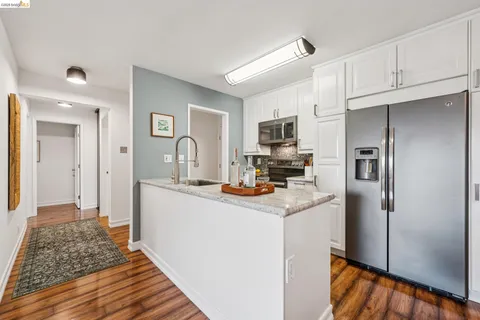 a kitchen with sink stove and refrigerator
