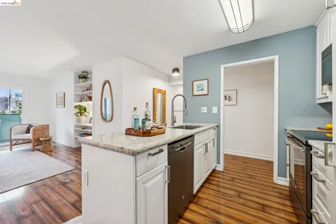 a kitchen with granite countertop a stove and a sink