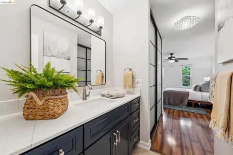 a bathroom with a granite countertop sink a toilet and a mirror