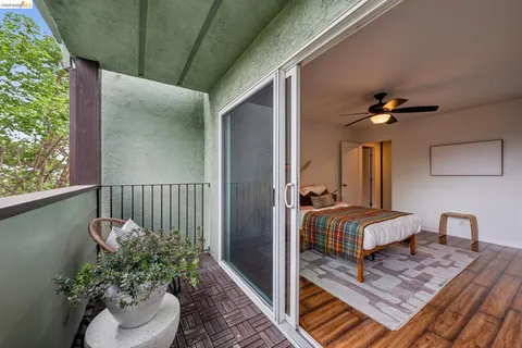 a balcony with a potted plant