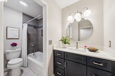 a white toilet sitting next to a white bath tub