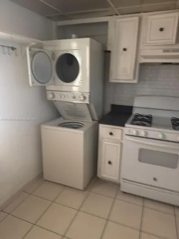 a white stove top oven sitting inside of a kitchen