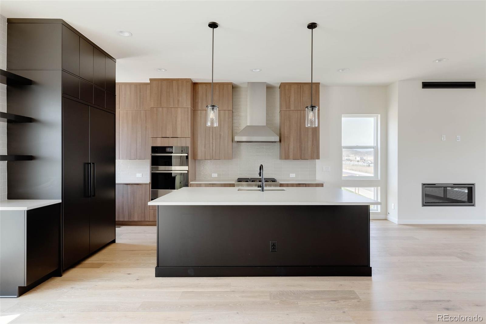 11468 Alla Breve Lone Tree, CO 80134 - Photo 11 of 34 a kitchen with kitchen island stainless steel appliances a sink stove and refrigerator