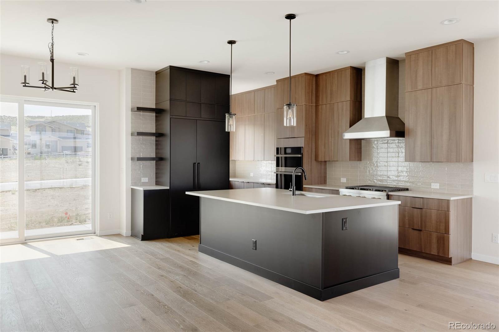 11468 Alla Breve Lone Tree, CO 80134 - Photo 12 of 34 a large kitchen with stainless steel appliances granite countertop a sink a stove and a refrigerator