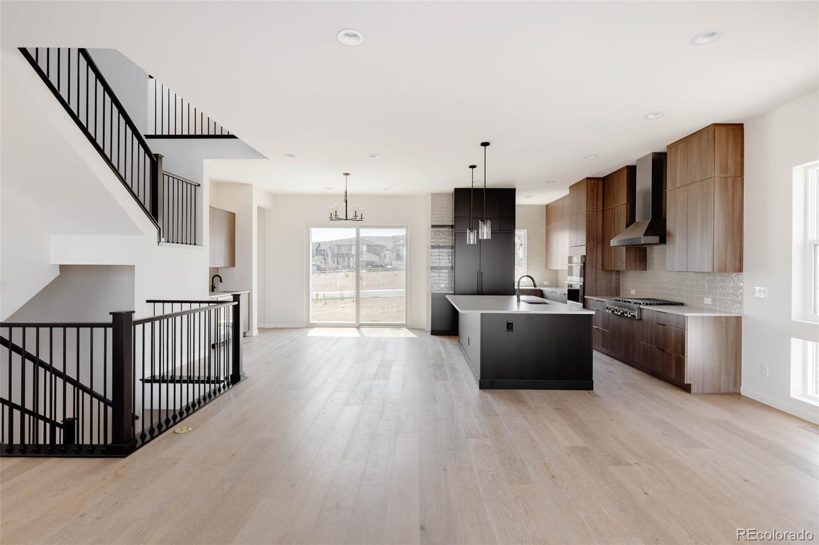 11468 Alla Breve Lone Tree, CO 80134 - Photo 13 of 34 a kitchen with stainless steel appliances kitchen island wooden floors granite top and stainless steel appliances