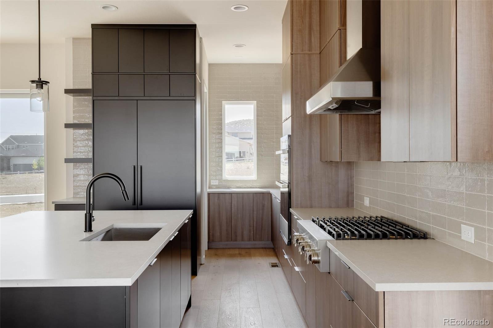 11468 Alla Breve Lone Tree, CO 80134 - Photo 14 of 34 a kitchen with a sink and a stove top oven
