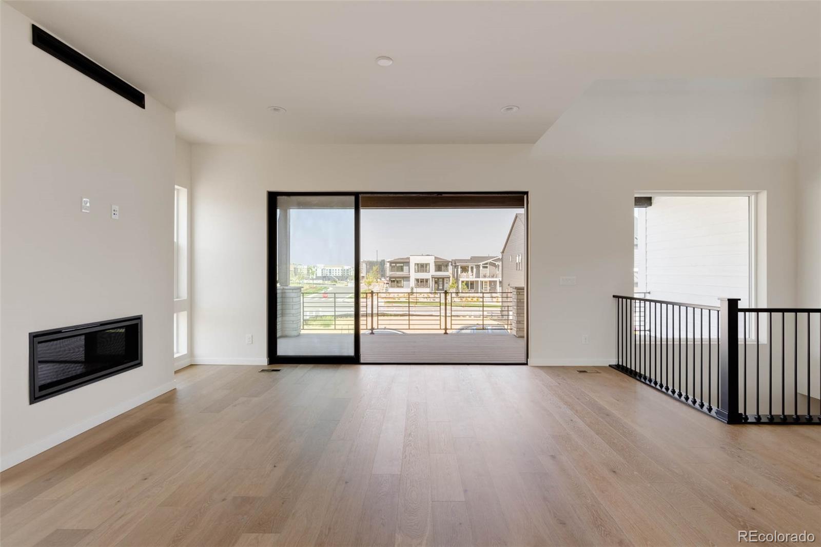 11468 Alla Breve Lone Tree, CO 80134 - Photo 16 of 34 a view of an empty room with wooden floor and a window