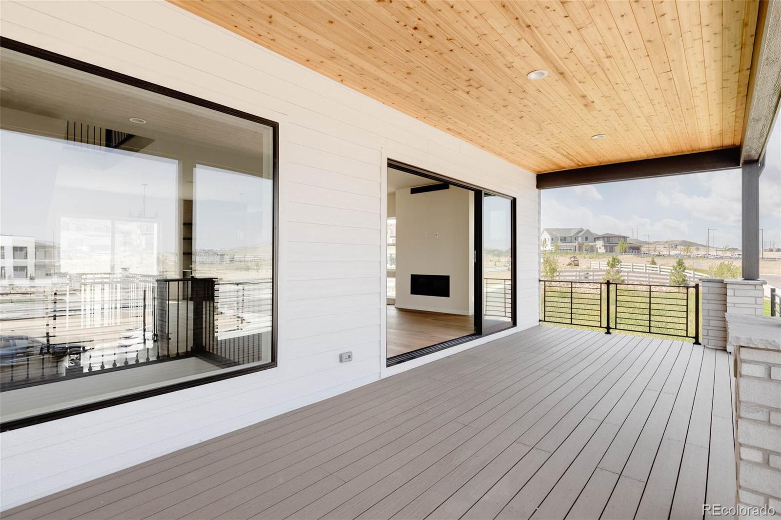 11468 Alla Breve Lone Tree, CO 80134 - Photo 18 of 34 a view of balcony with floor to ceiling window and wooden floor